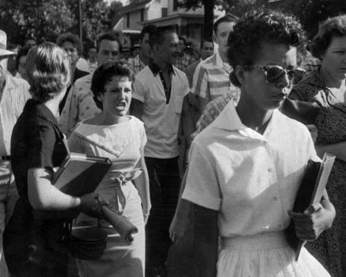 Whites taunt a lone black student on the first day of integration of Little Rock's Central High School in 1957. Federal troops were sent in by President Eisenhower to restore order and enforce integrat