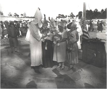 Anti-Black Violence- KKK- A baby being inducted into the Ku Klux Klan in south Dade County circa 1940s