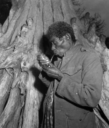 Black Seminoles An aged Black Seminole and his pipe Everglades Florida 1952