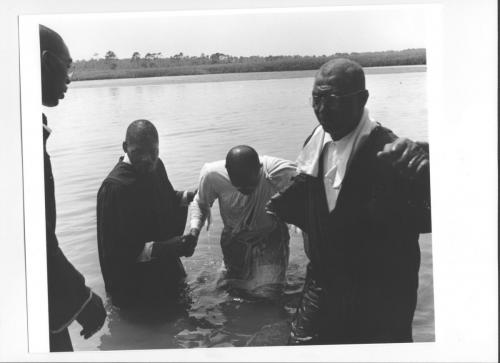 Church- Exhausted pastor is helped from the water after several baptizings undated Florida State Archives