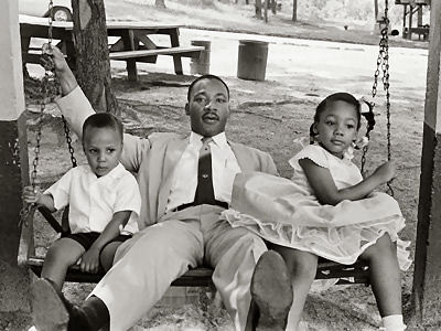 civil rights dr-martin-luther-king-jr-and-children-on-swing