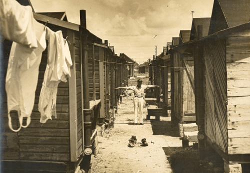 overtown crowded housing man arms outstretched